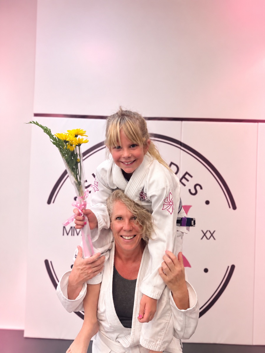 A mother and her daughter in their gis at Six Blades Jiu Jitsu South Denver